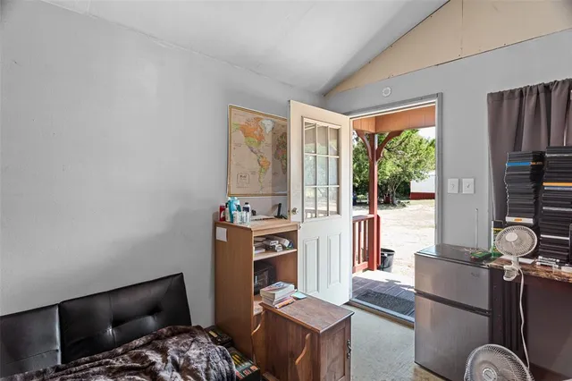 a bedroom with furniture and a flat screen tv