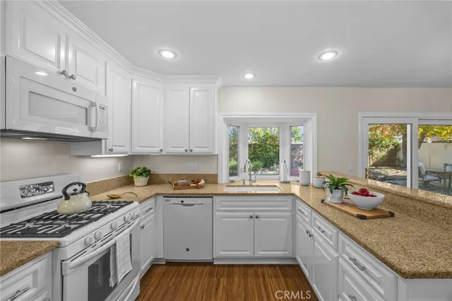 a kitchen that has a lot of cabinets in it and a window