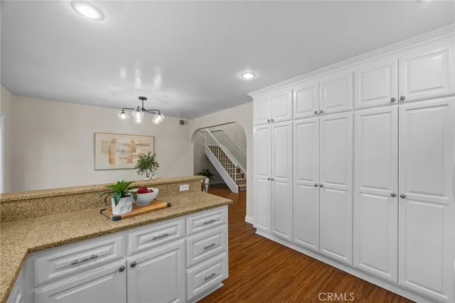 a view of a storage and utility room with wooden floor