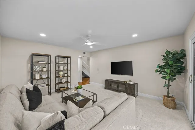 a living room with furniture and a potted plant