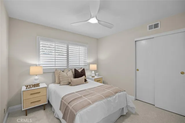 a bedroom with a bed and a ceiling fan