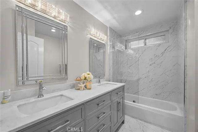 a bathroom with a tub sink and mirror