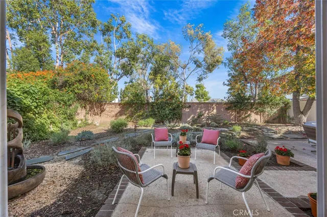 a view of backyard with outdoor seating and trees