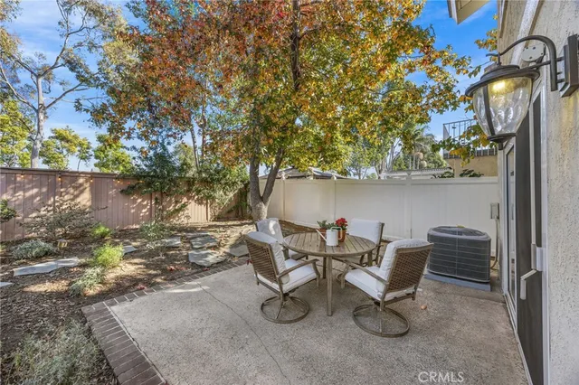 a view of a chairs and table in the back yard of the house