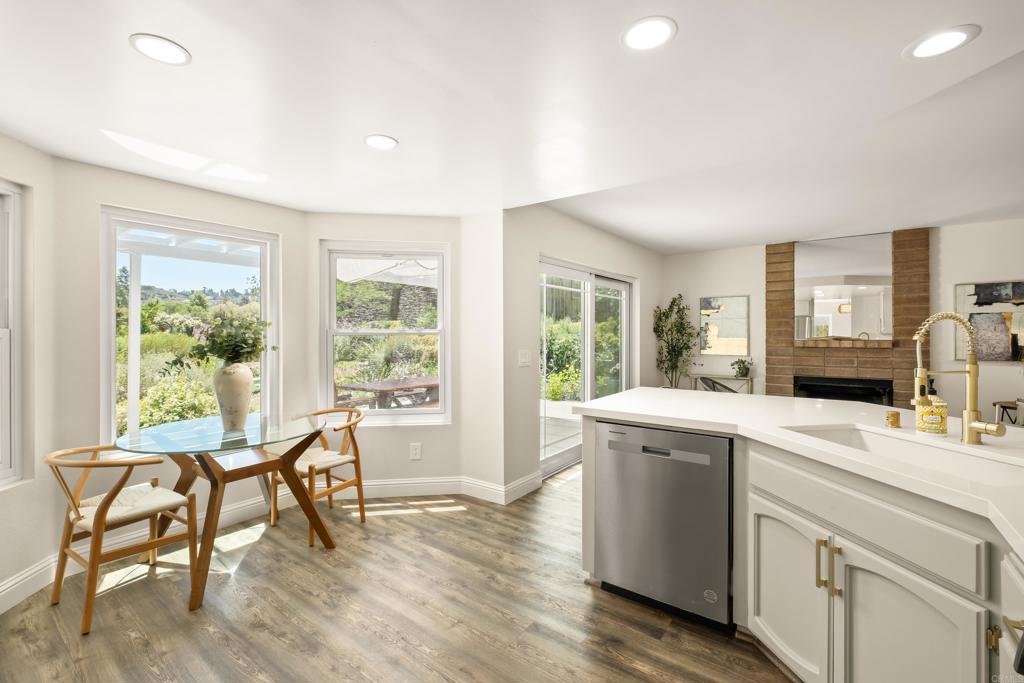 1361 Hodges Road Oceanside, CA 92056 - Photo 13 of 39 a view of a kitchen area with furniture and wooden floors