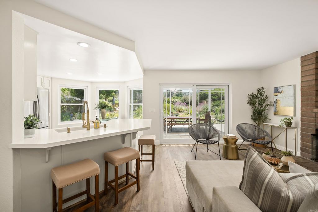 1361 Hodges Road Oceanside, CA 92056 - Photo 14 of 39 a living room with furniture and large windows