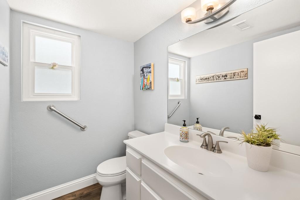 1361 Hodges Road Oceanside, CA 92056 - Photo 18 of 39 a bathroom with a sink mirror and toilet