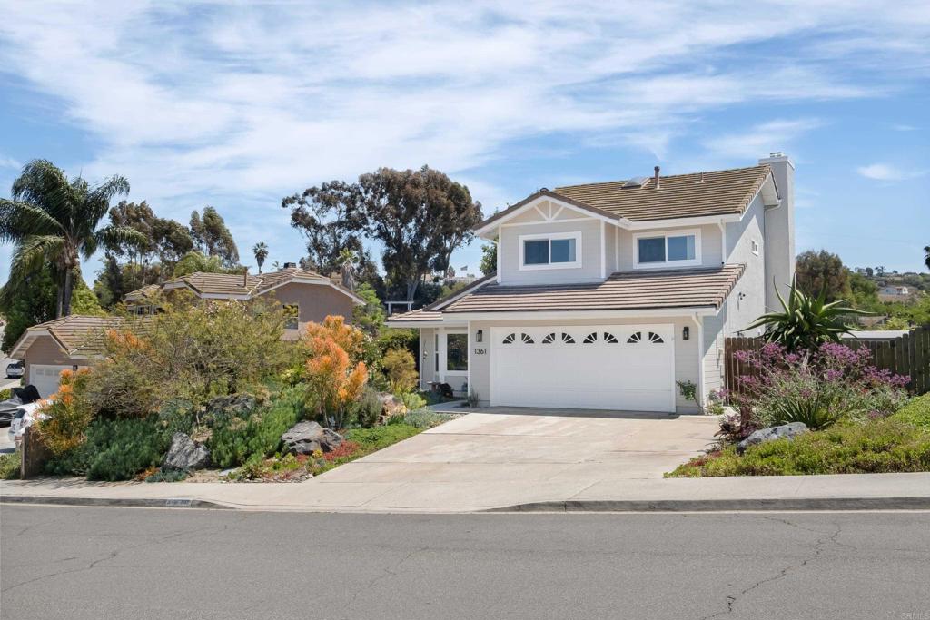 1361 Hodges Road Oceanside, CA 92056 - Photo 2 of 39 a front view of a house with a garden