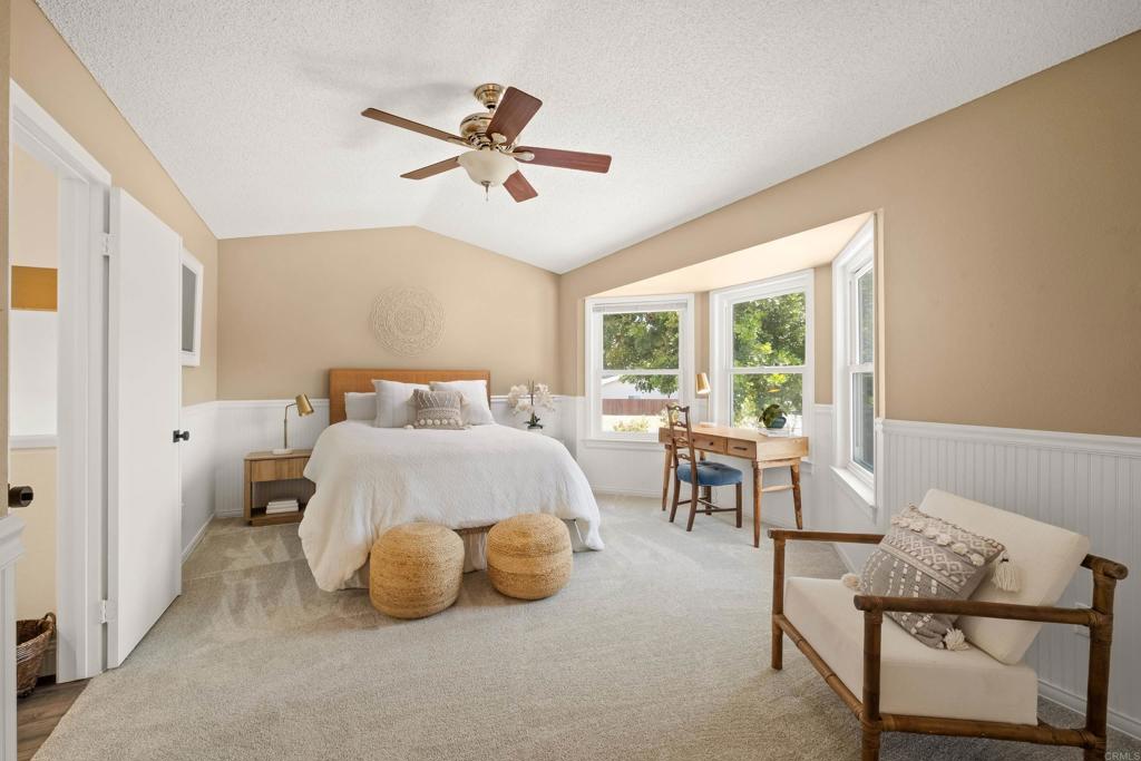 1361 Hodges Road Oceanside, CA 92056 - Photo 25 of 39 a bedroom with a bed and large windows