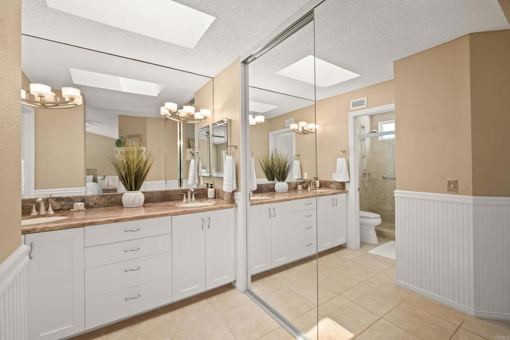 1361 Hodges Road Oceanside, CA 92056 - Photo 28 of 39 a bathroom with a double vanity sink mirror and