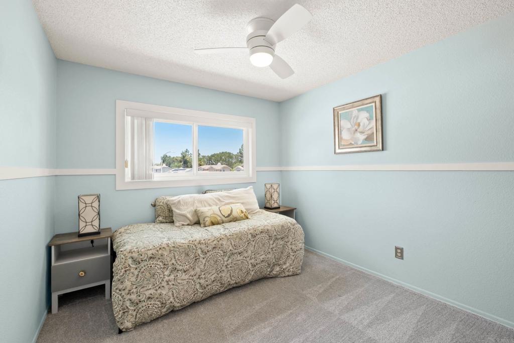 1361 Hodges Road Oceanside, CA 92056 - Photo 31 of 39 a bedroom with a bed and a painting on the wall