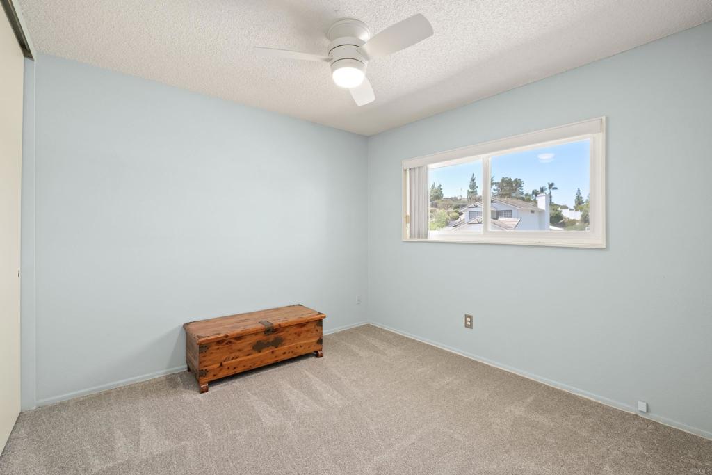 1361 Hodges Road Oceanside, CA 92056 - Photo 33 of 39 an empty room with windows and ceiling fan