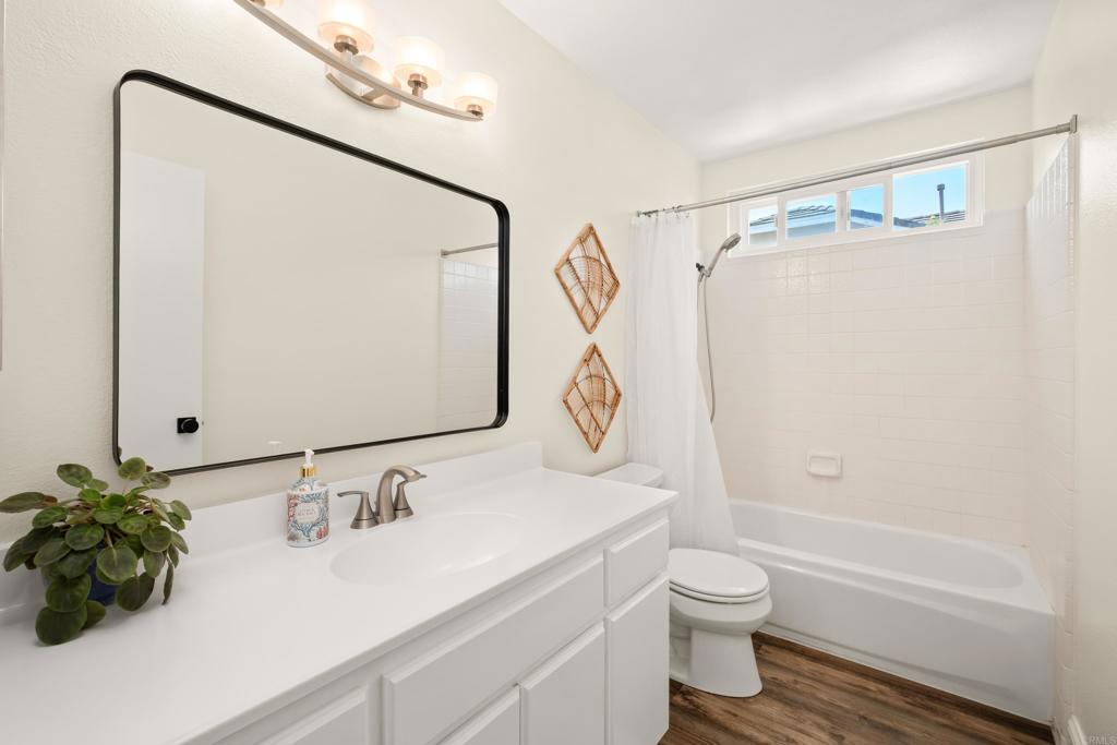 1361 Hodges Road Oceanside, CA 92056 - Photo 35 of 39 a bathroom with a granite countertop sink toilet and shower