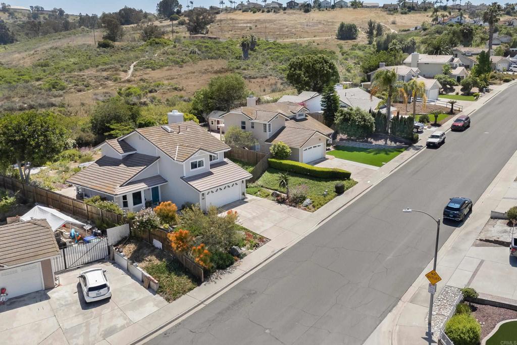 1361 Hodges Road Oceanside, CA 92056 - Photo 36 of 39 an aerial view of a house with a garden and mountain view