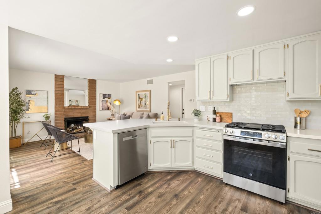 1361 Hodges Road Oceanside, CA 92056 - Photo 8 of 39 a kitchen with a stove top oven sink and cabinets