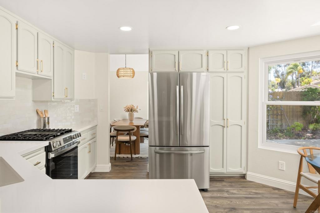 1361 Hodges Road Oceanside, CA 92056 - Photo 9 of 39 a kitchen with stainless steel appliances a refrigerator a stove a sink and a window