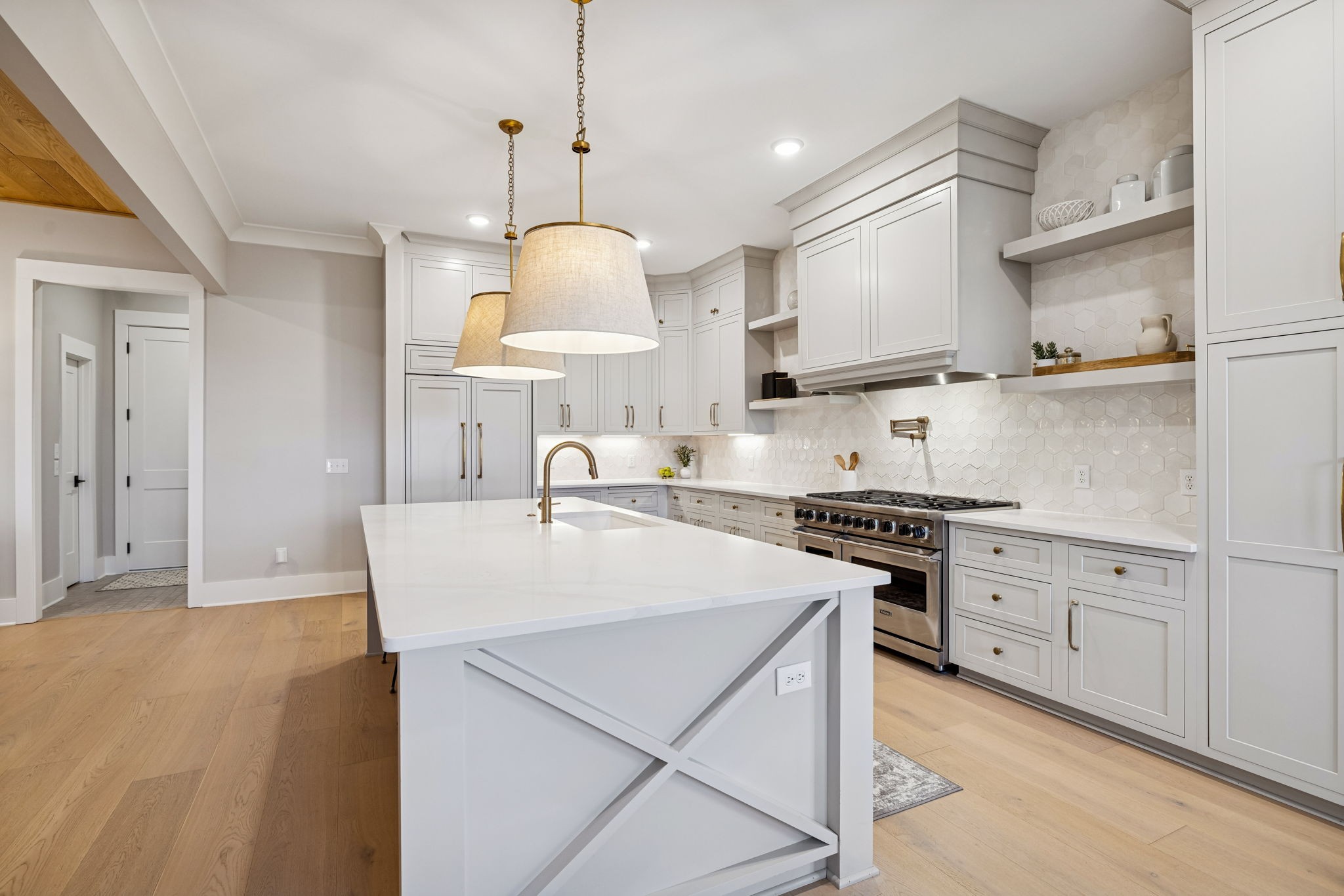 137 Alfred Ladd Road Franklin, TN 37064 - Photo 31 of 99 a kitchen with stainless steel appliances a stove a sink a center island a refrigerator and a wooden floor