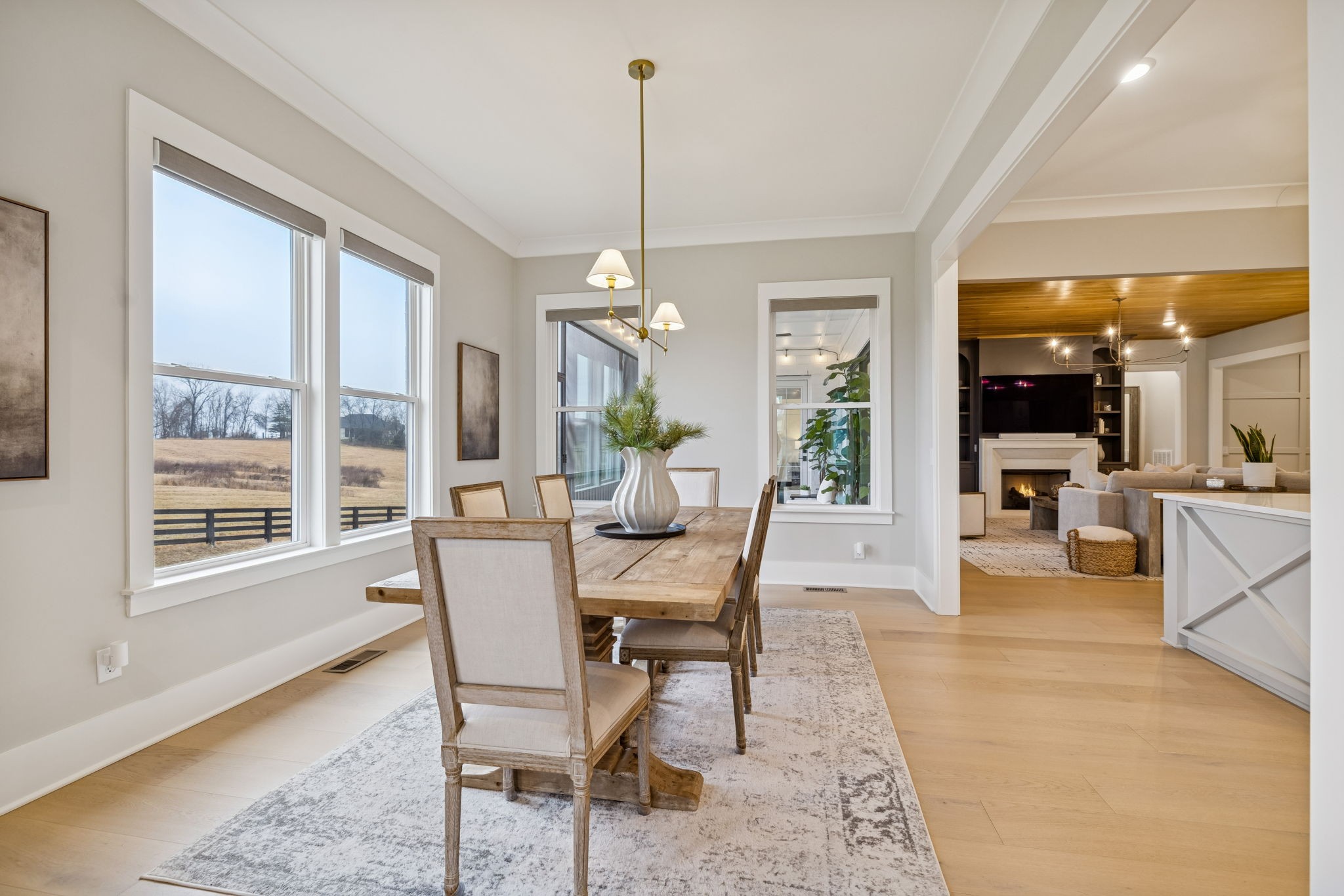 137 Alfred Ladd Road Franklin, TN 37064 - Photo 43 of 99 a dining room with wooden floor a chandelier a glass table and chairs