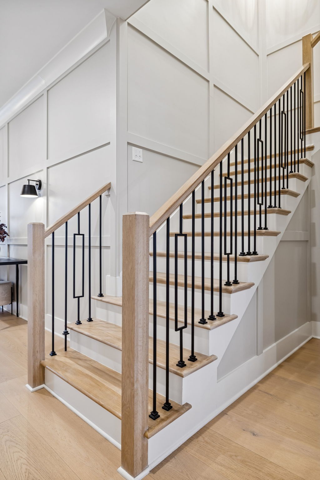 137 Alfred Ladd Road Franklin, TN 37064 - Photo 69 of 99 a view of staircase with lots of frames on wall and wooden floor