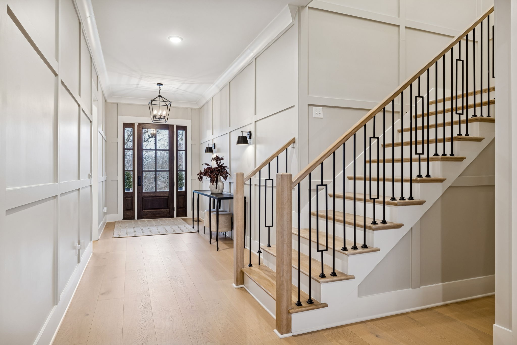 137 Alfred Ladd Road Franklin, TN 37064 - Photo 10 of 99 a view of staircase with lots of frames on wall and wooden floor