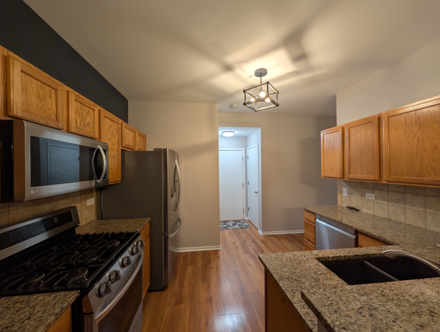 671 Fieldcrest Drive South Elgin, IL 60177 - Photo 13 of 22 a kitchen with granite countertop a sink cabinets and stainless steel appliances