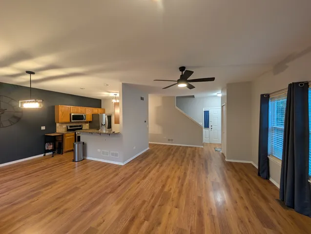 a view of a kitchen with a sink and a refrigerator