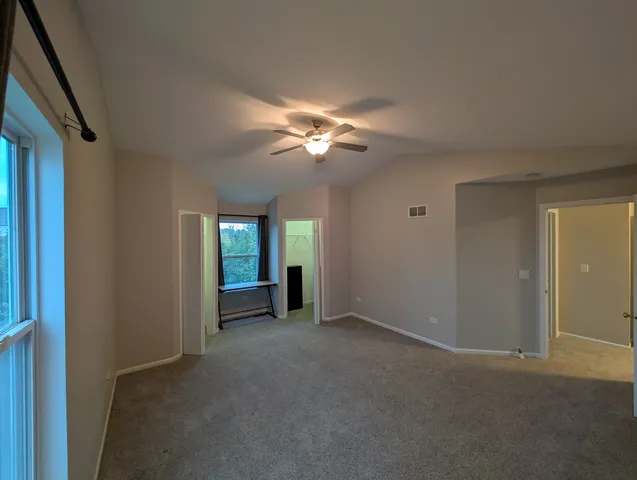 a view of an empty room with a ceiling fan