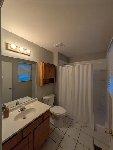 a bathroom with a sink a toilet and mirror