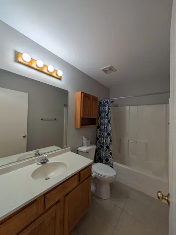 a bathroom with a sink a toilet a shower and a mirror