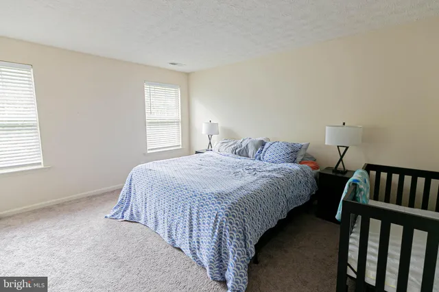 a bedroom with bed and a window