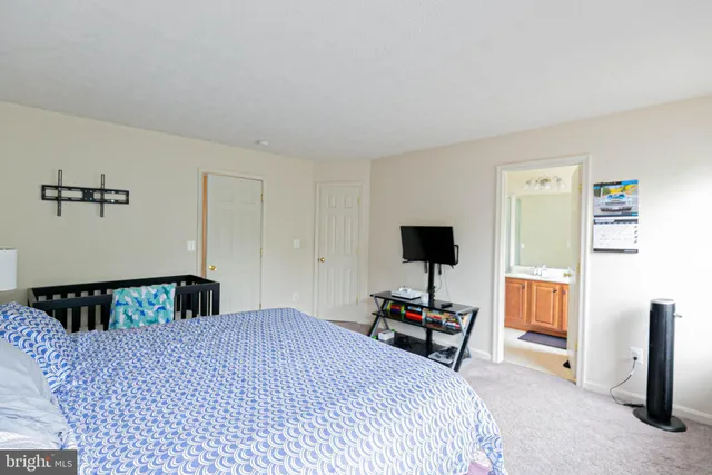 a bedroom with a bed and a flat tv screen