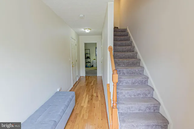 a view of entryway and hall with wooden floor
