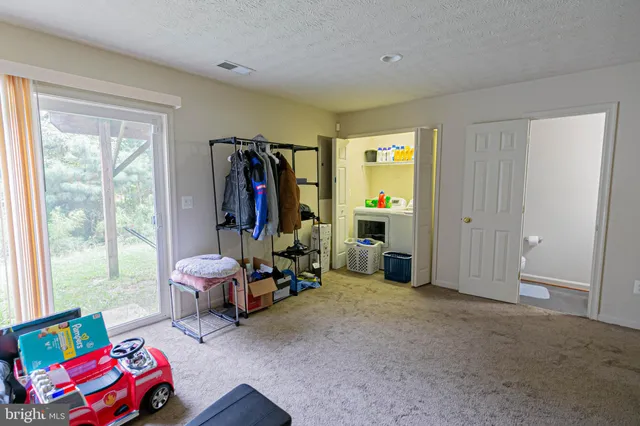 a bedroom with furniture and a window