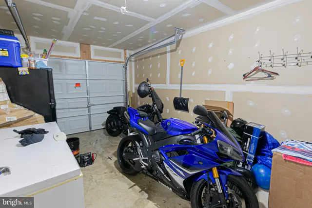 a kitchen with a dining table chairs and chandelier