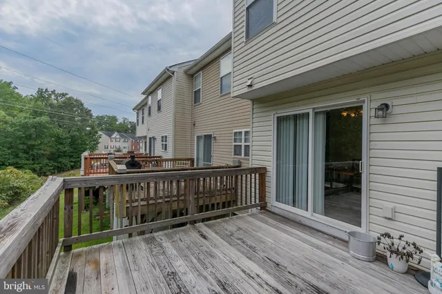 a view of balcony with wooden floor and fence