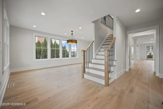 a view of a dining room with furniture wooden floor and chandelier