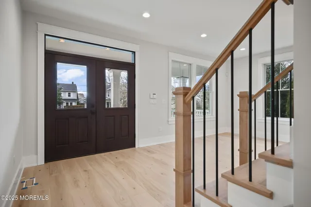 a large white kitchen with a large window