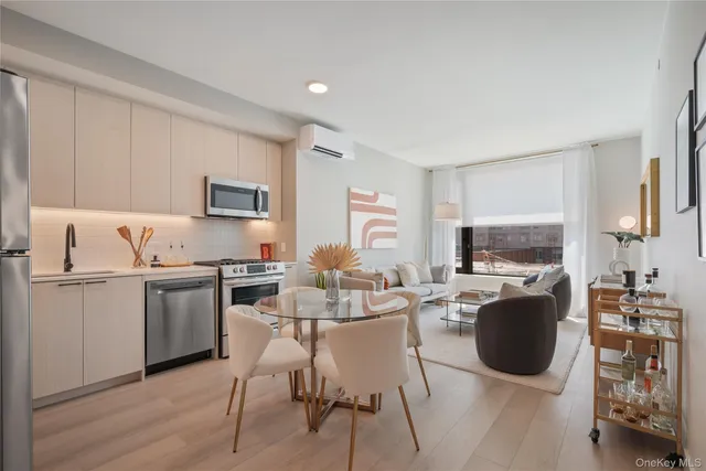 a living room with furniture a flat screen tv and a window