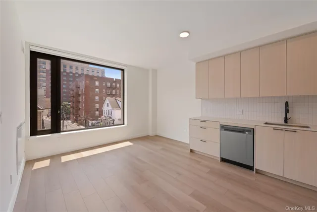 a view of a kitchen with a sink stove and cabinets