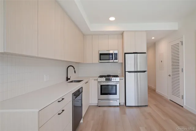a kitchen with a sink a stove and refrigerator