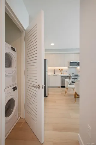 a view of a kitchen with fridge and workspace