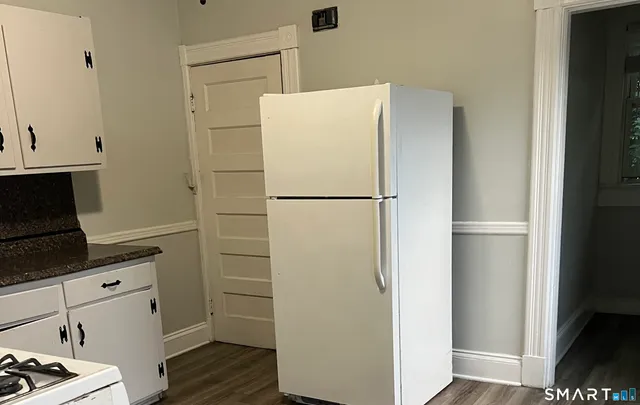 a white refrigerator freezer sitting in a kitchen