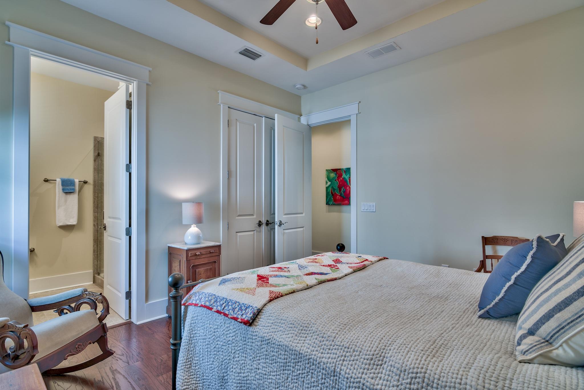 664 Flatwoods Forest Loop Santa Rosa Beach, FL 32459 - Photo 13 of 33 a bedroom with a bed and a chandelier