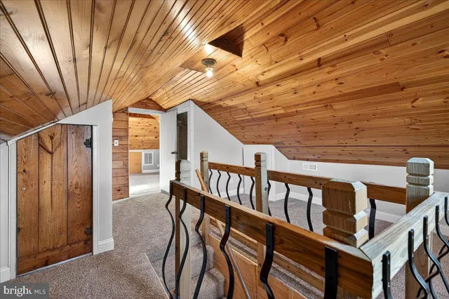 a view of an chairs and deck in the backyard