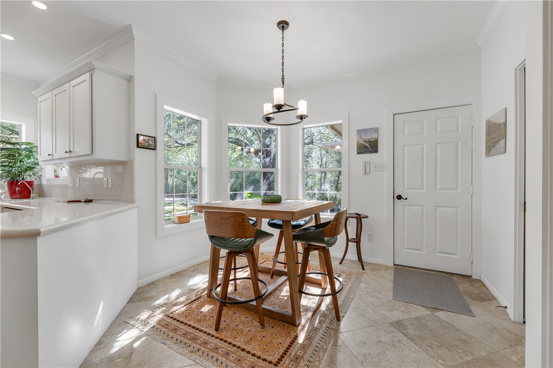 9618 Whispering Ridge College Station, TX 77845 - Photo 11 of 27 a dining room with furniture a chandelier and wooden floor