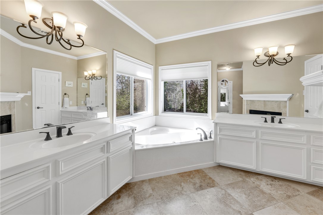 9618 Whispering Ridge College Station, TX 77845 - Photo 16 of 27 a large white bathroom with a large tub sink and vanity