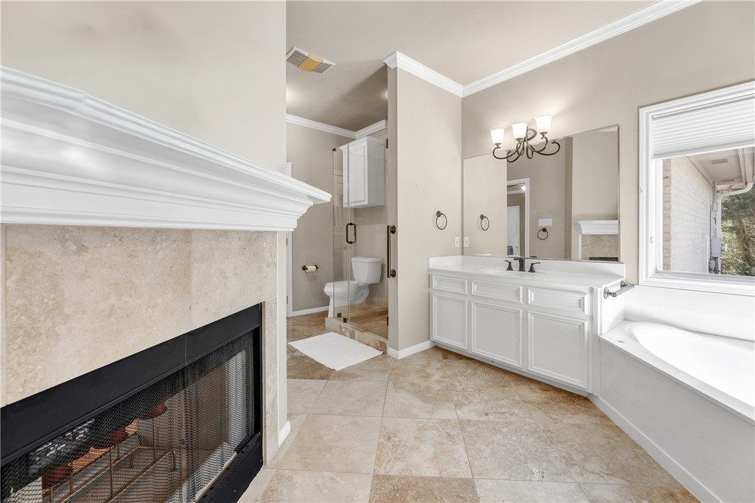 9618 Whispering Ridge College Station, TX 77845 - Photo 17 of 27 a spacious bathroom with a double vanity sink a mirror and a bathtub