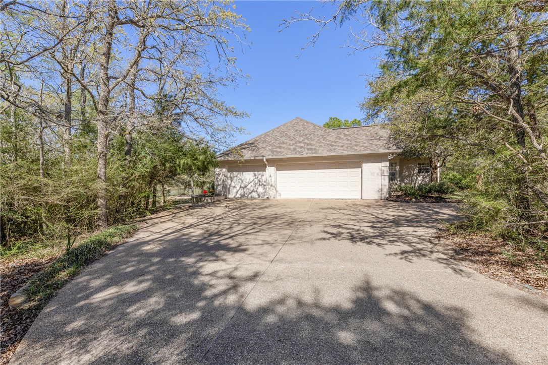 9618 Whispering Ridge College Station, TX 77845 - Photo 24 of 27 a view of a house with a large tree and a yard