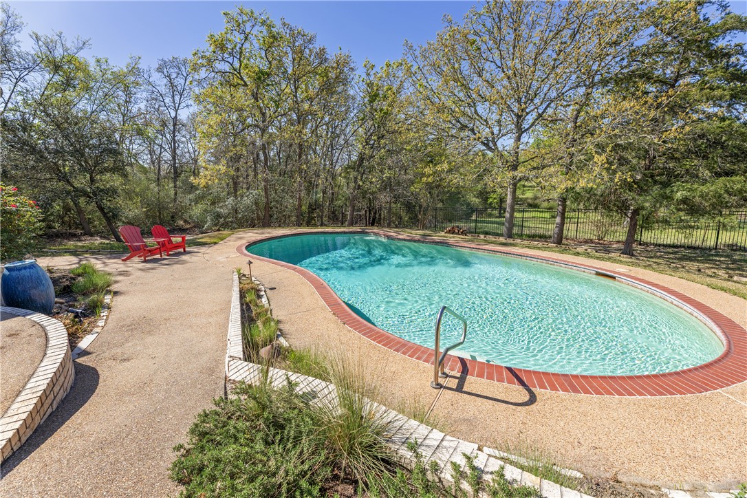 9618 Whispering Ridge College Station, TX 77845 - Photo 26 of 27 an aerial view of a swimming pool with a yard