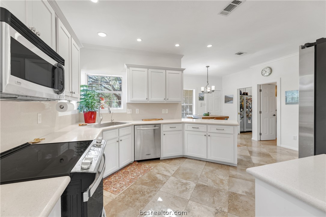 9618 Whispering Ridge College Station, TX 77845 - Photo 6 of 27 a kitchen with sink cabinets and microwave